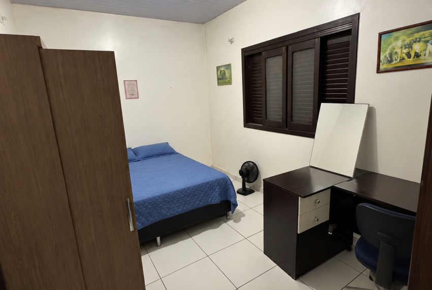 a_wide_angle_indoor_photograph_of_the_same_bedroo